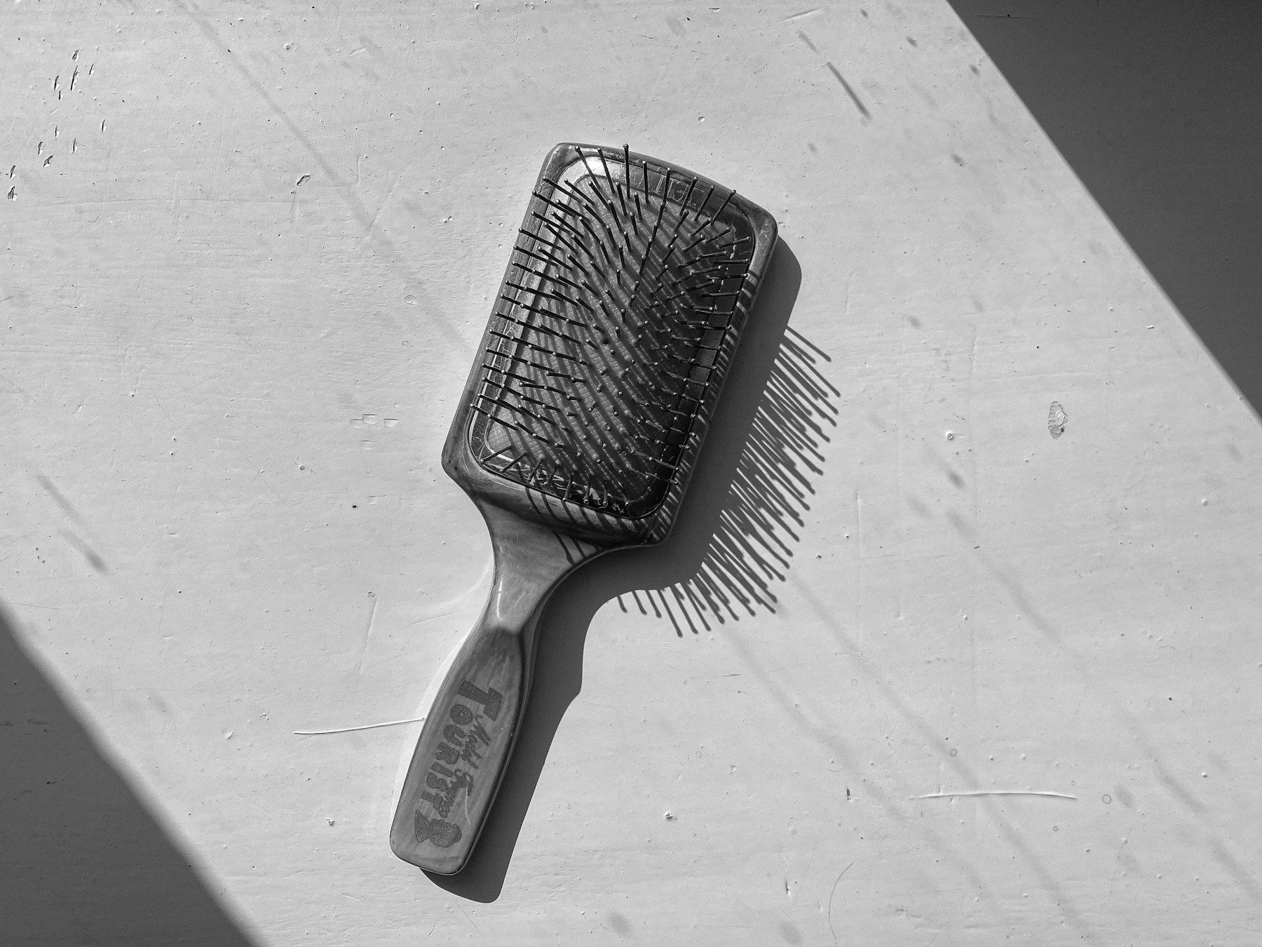 A black and white photo of a hair brush
