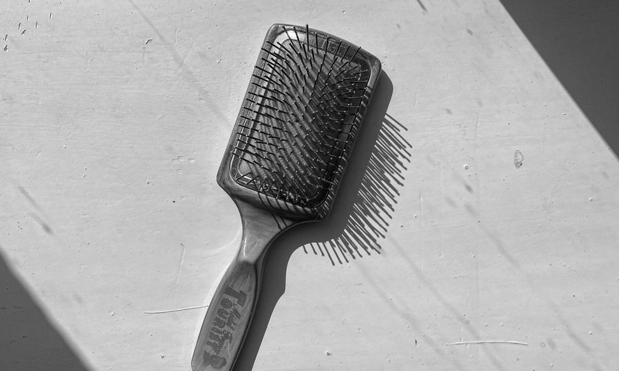 A black and white photo of a hair brush