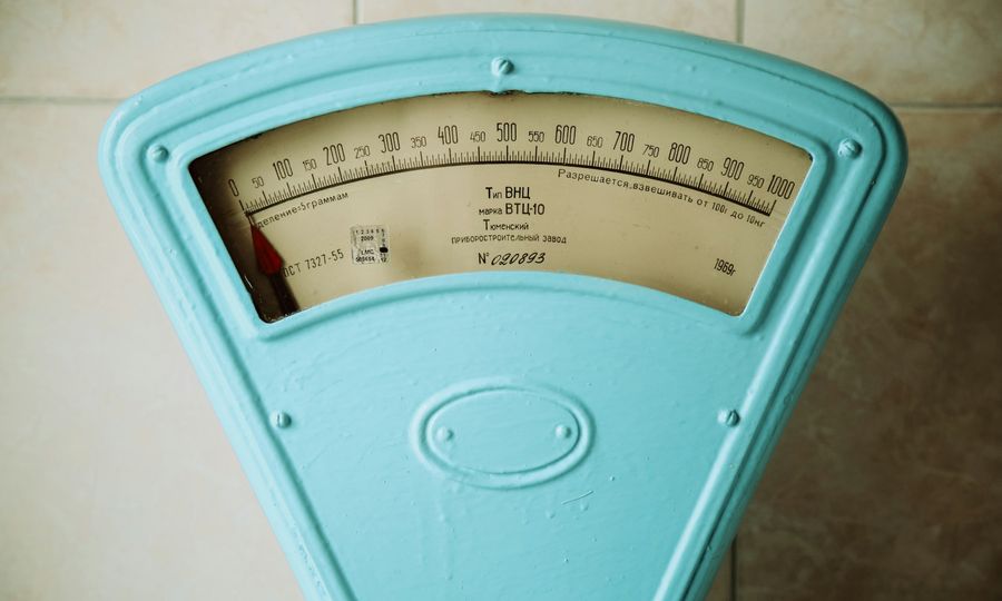 A close up of a meter on a tiled wall