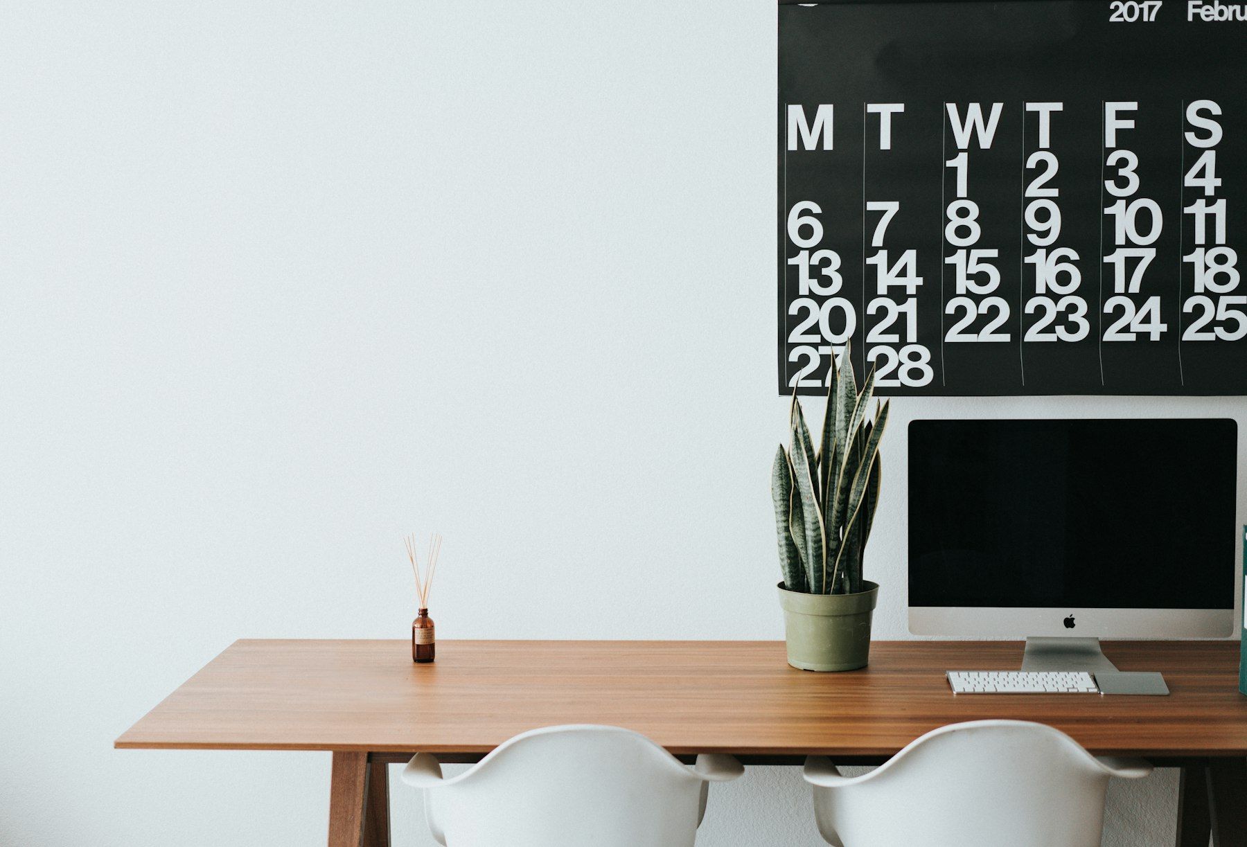 Silver iMac on brown wooden desk
