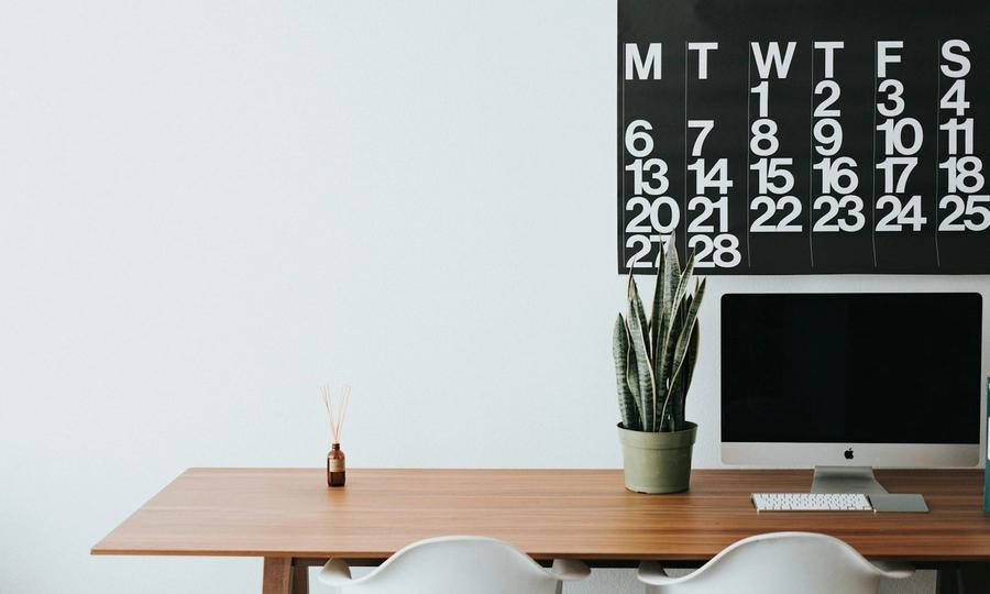Silver iMac on brown wooden desk