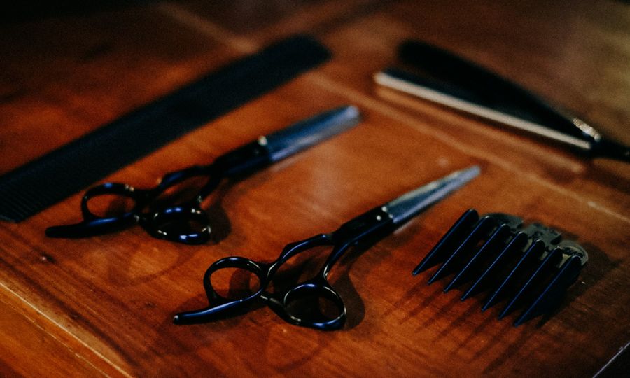 Black framed eyeglasses beside black pen