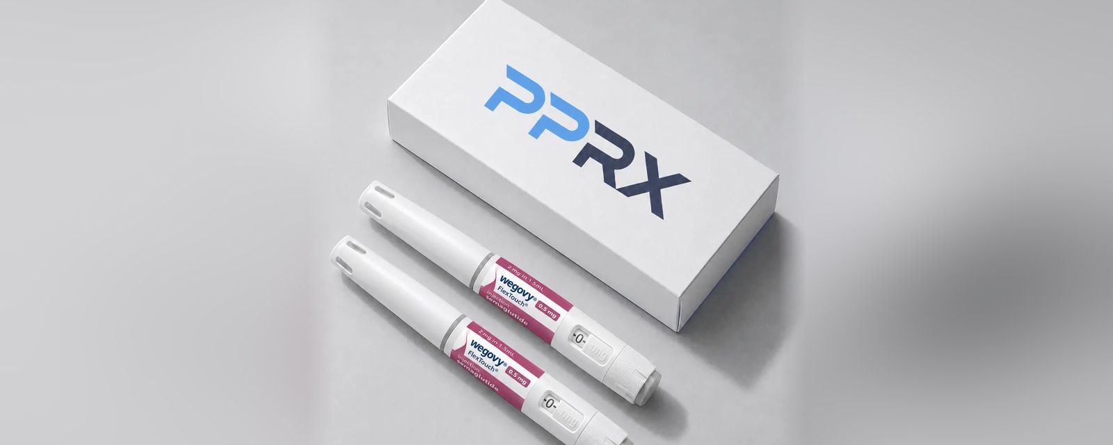 PPRX box with two Wegovy 0.5mg pens on a grey studio background