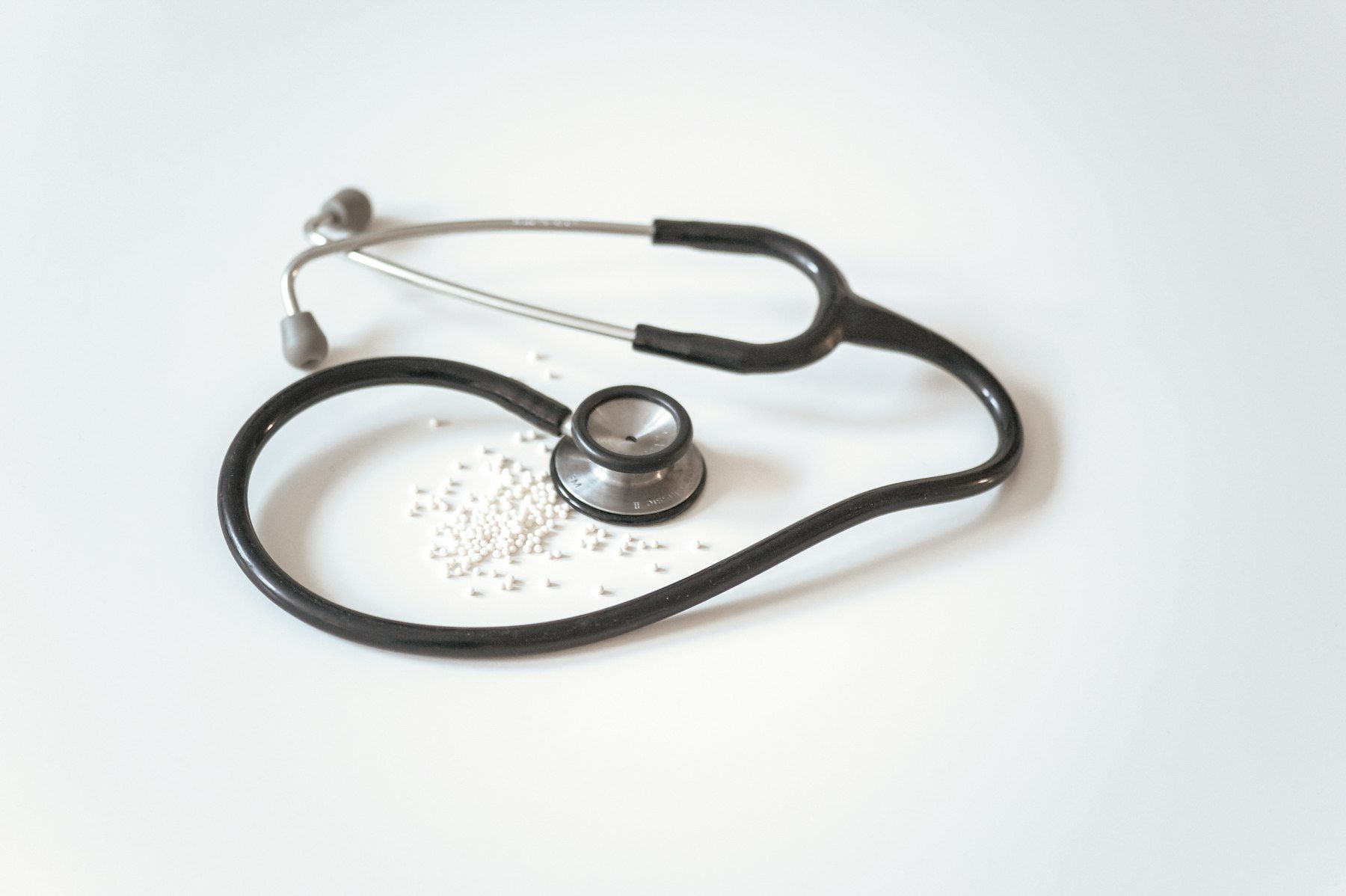 Black and silver stethoscope on white surface