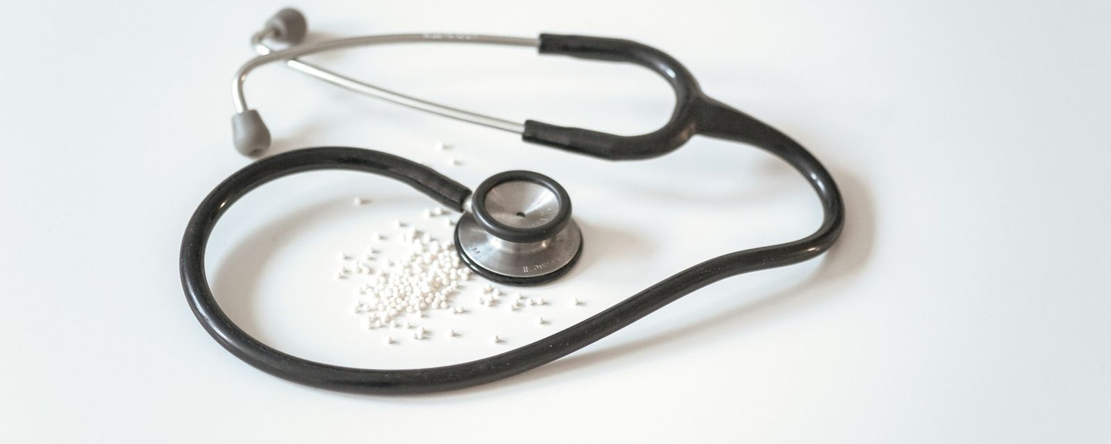 Black and silver stethoscope on white surface