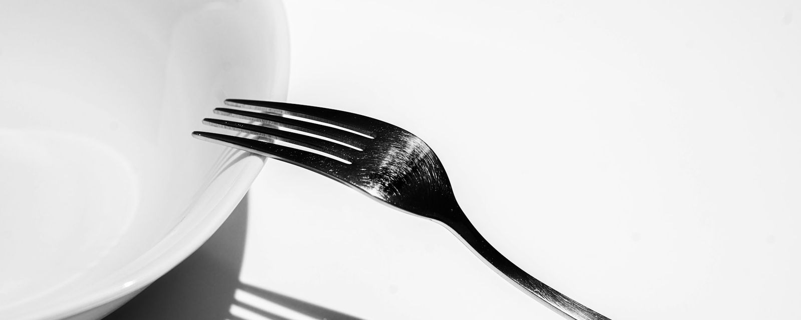 Silver fork on white ceramic plate