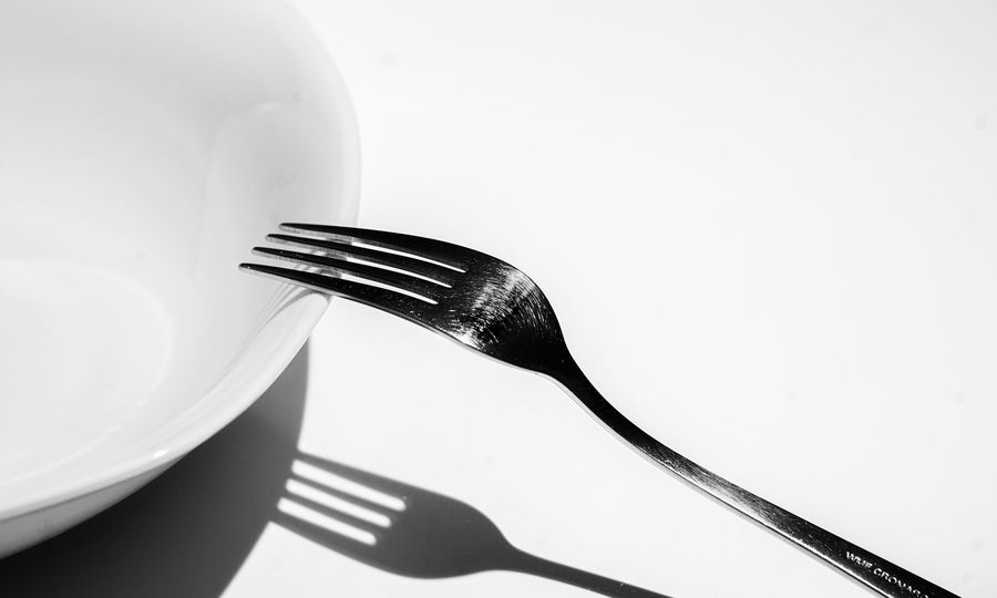Silver fork on white ceramic plate