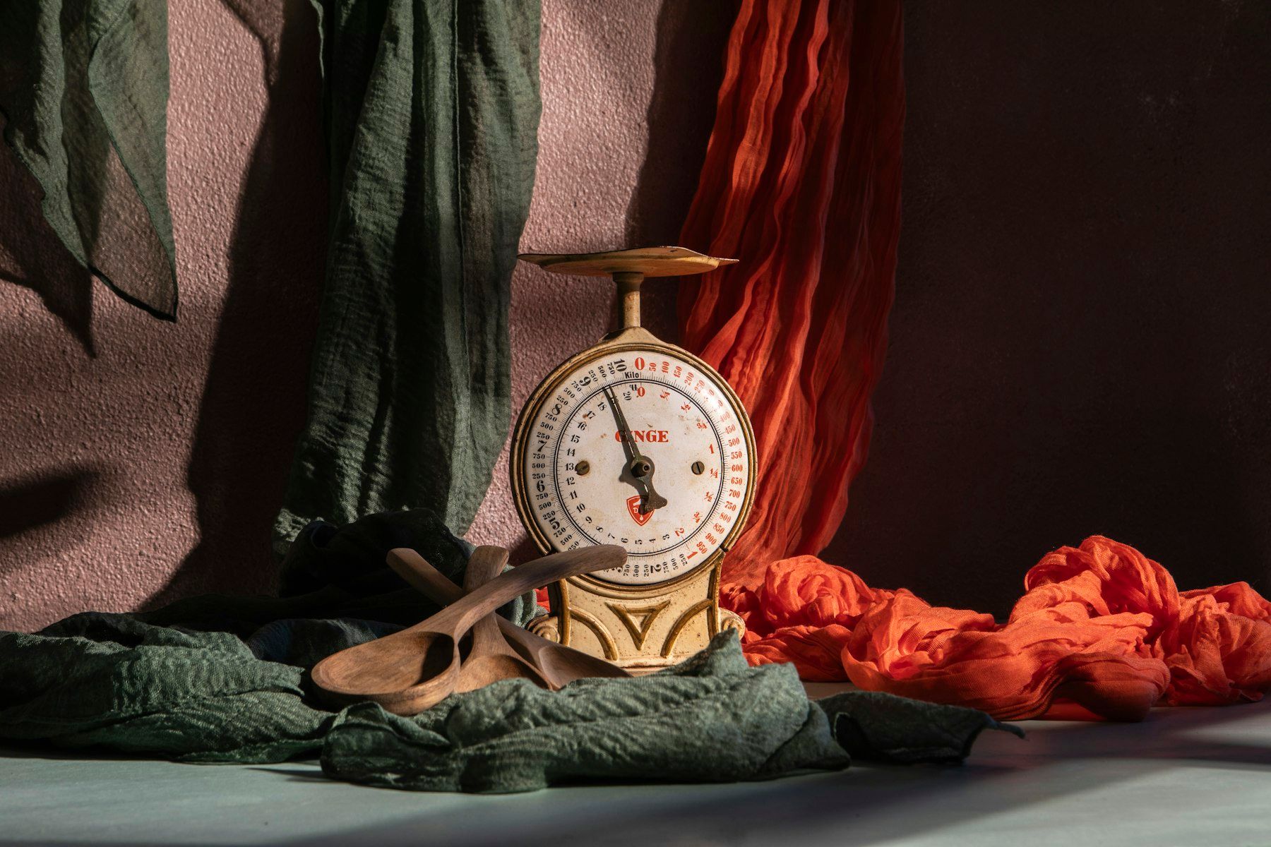 A vintage scale is posed with colorful fabrics