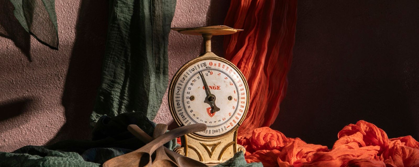 A vintage scale is posed with colorful fabrics