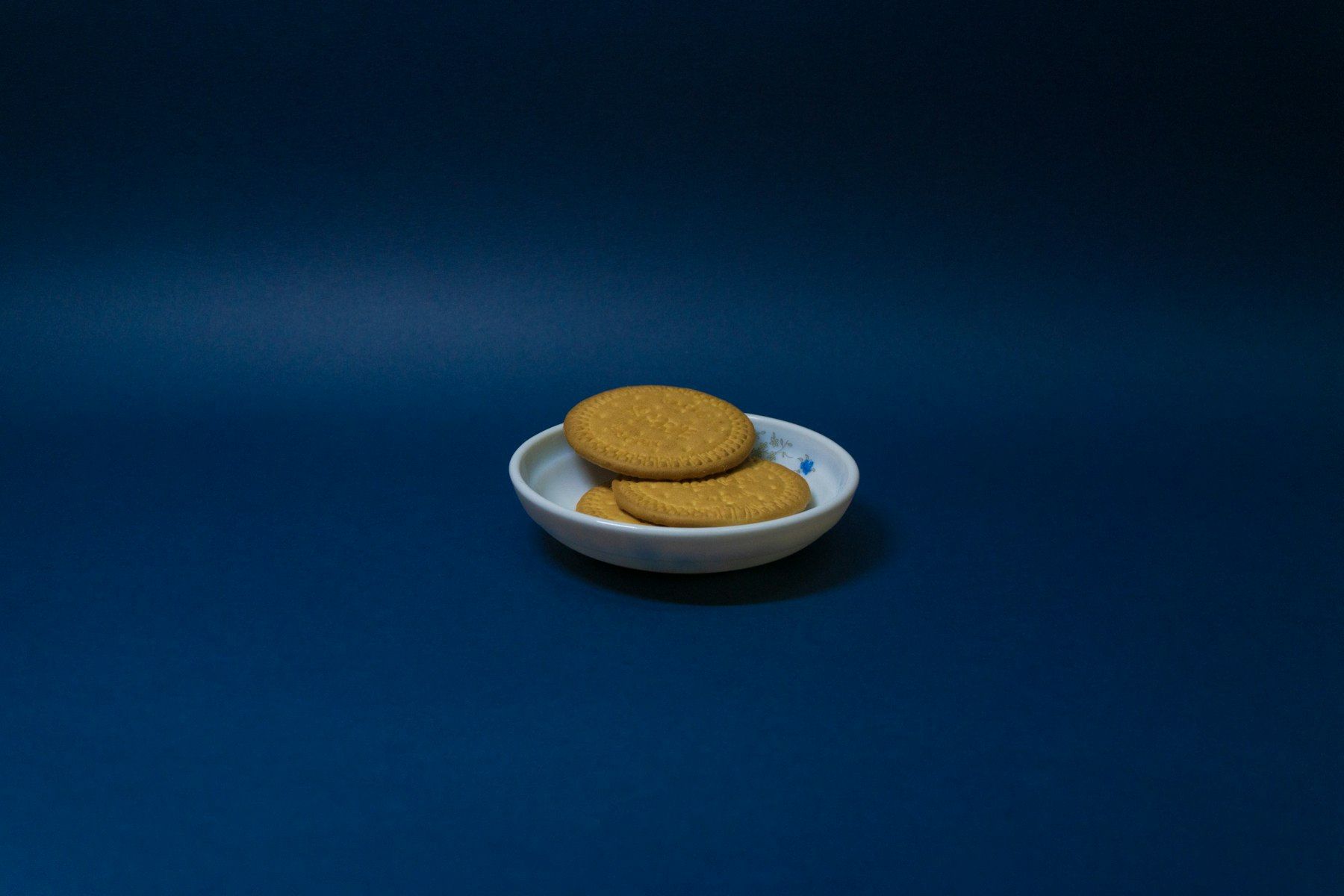 White ceramic bowl on white ceramic saucer