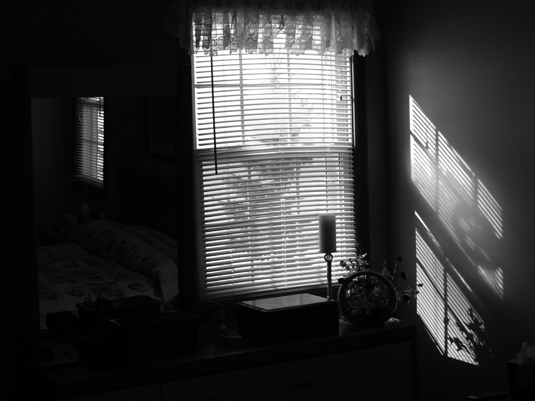 A black and white photo of a bedroom