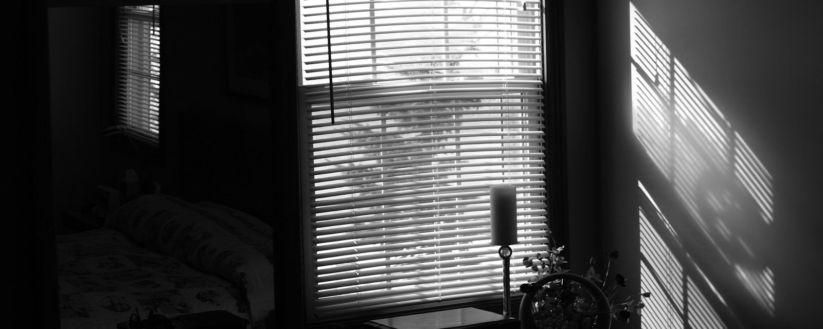 A black and white photo of a bedroom