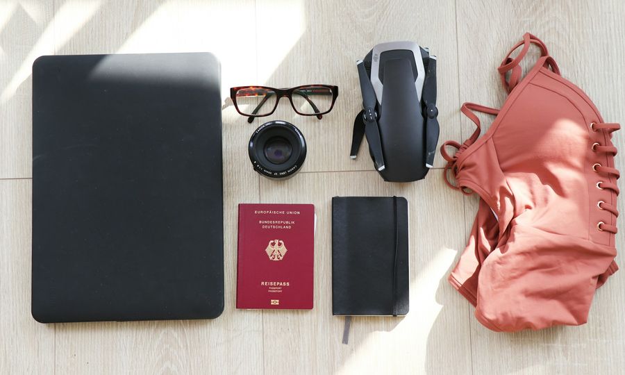 Laptop, eyeglasses, passport, notebook, drone and swimsuit