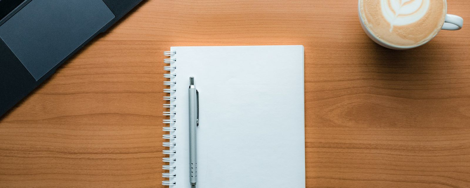 A pen and a cup of coffee on a table