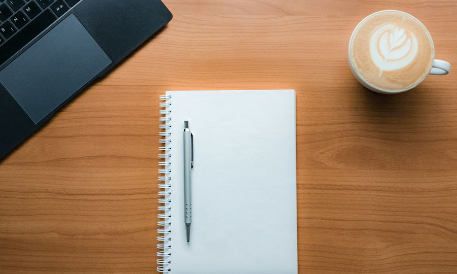 A pen and a cup of coffee on a table