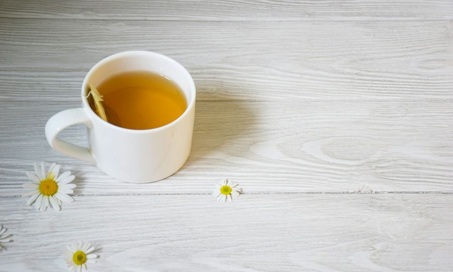 A cup of tea sitting on top of a white table