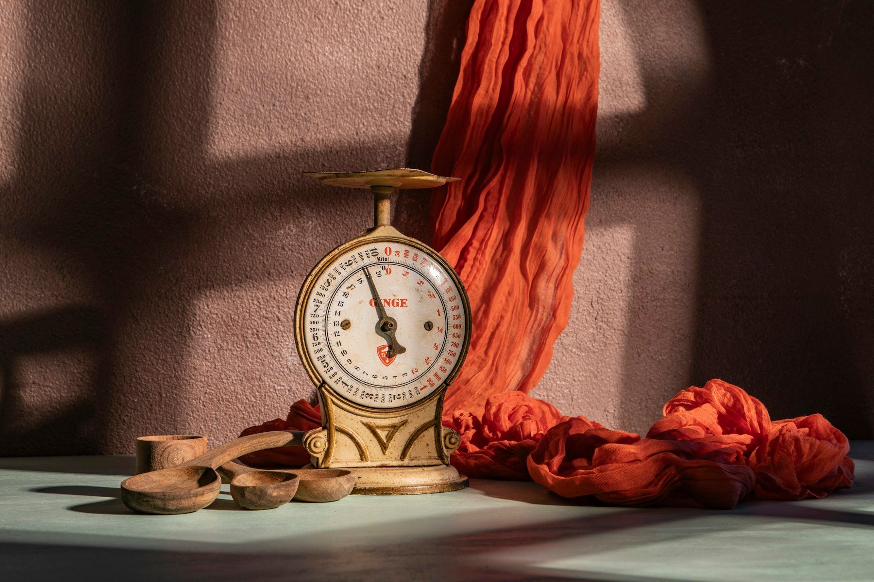 A scale and fabric, in a softly lit setting