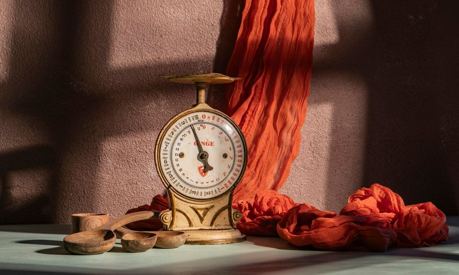 A scale and fabric, in a softly lit setting
