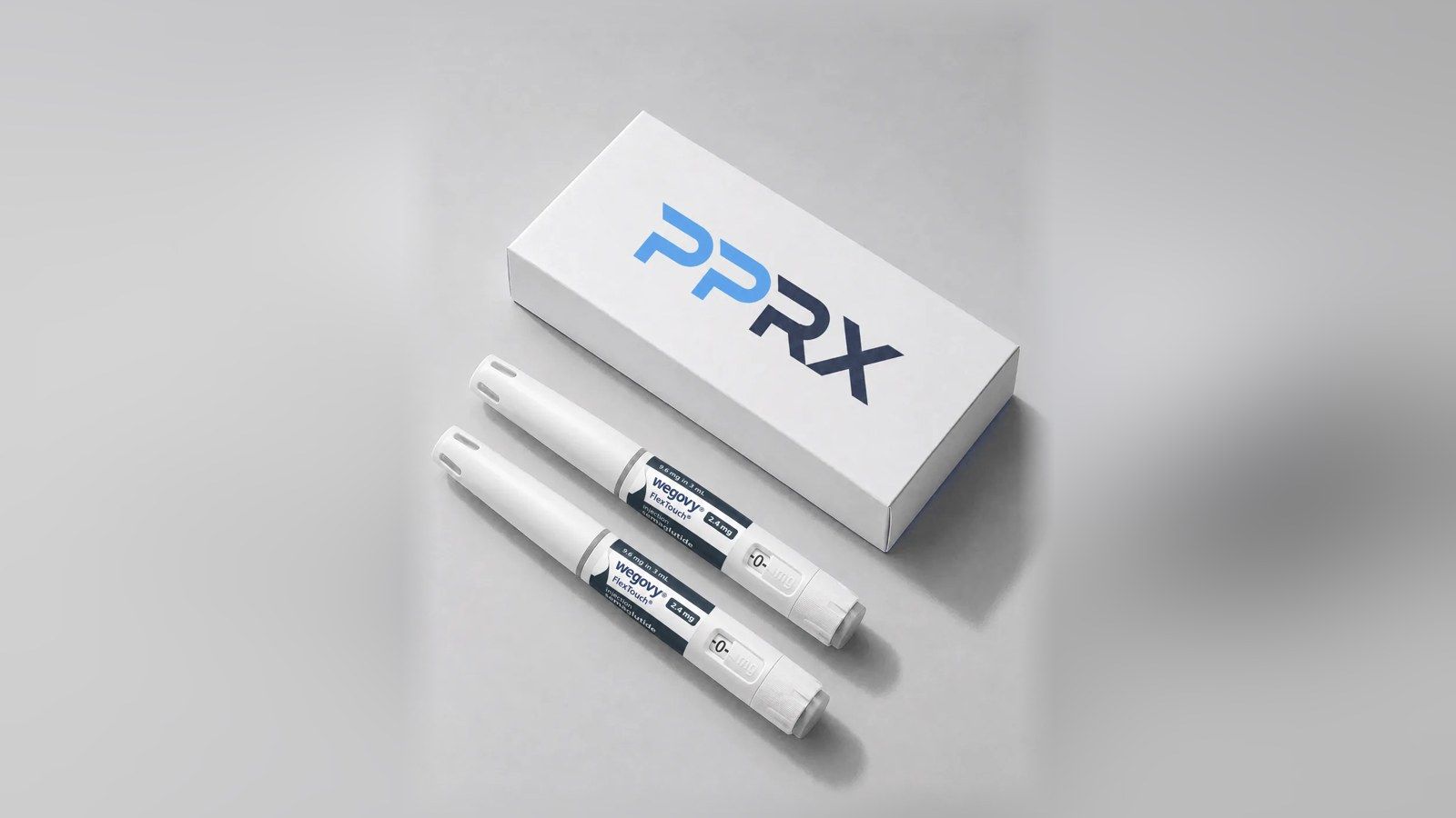 PPRX box with two Wegovy 2.4mg pens on a grey studio background