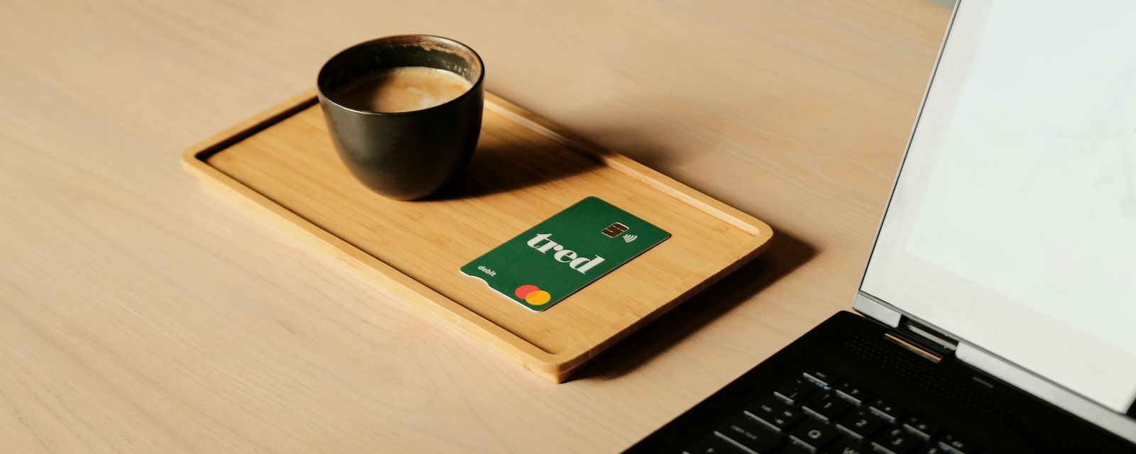 A laptop computer sitting on top of a wooden desk