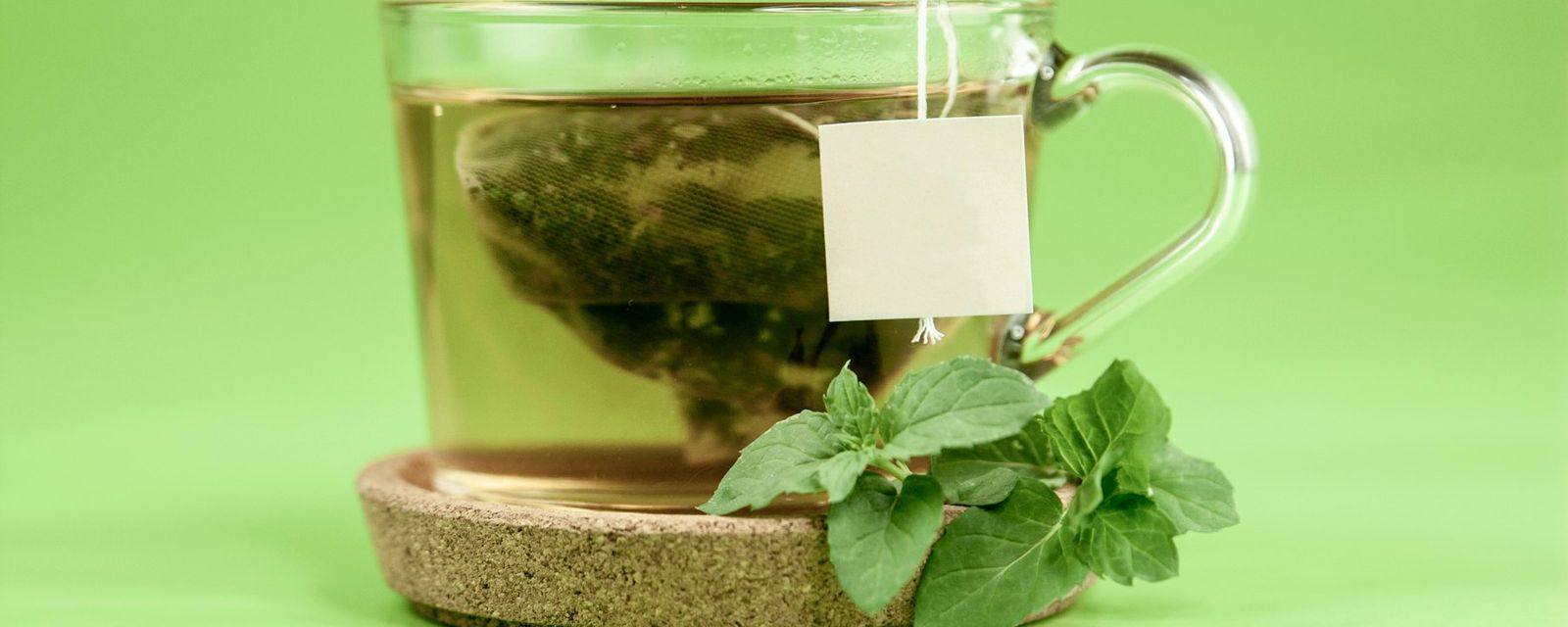 Clear glass mug with green leaves