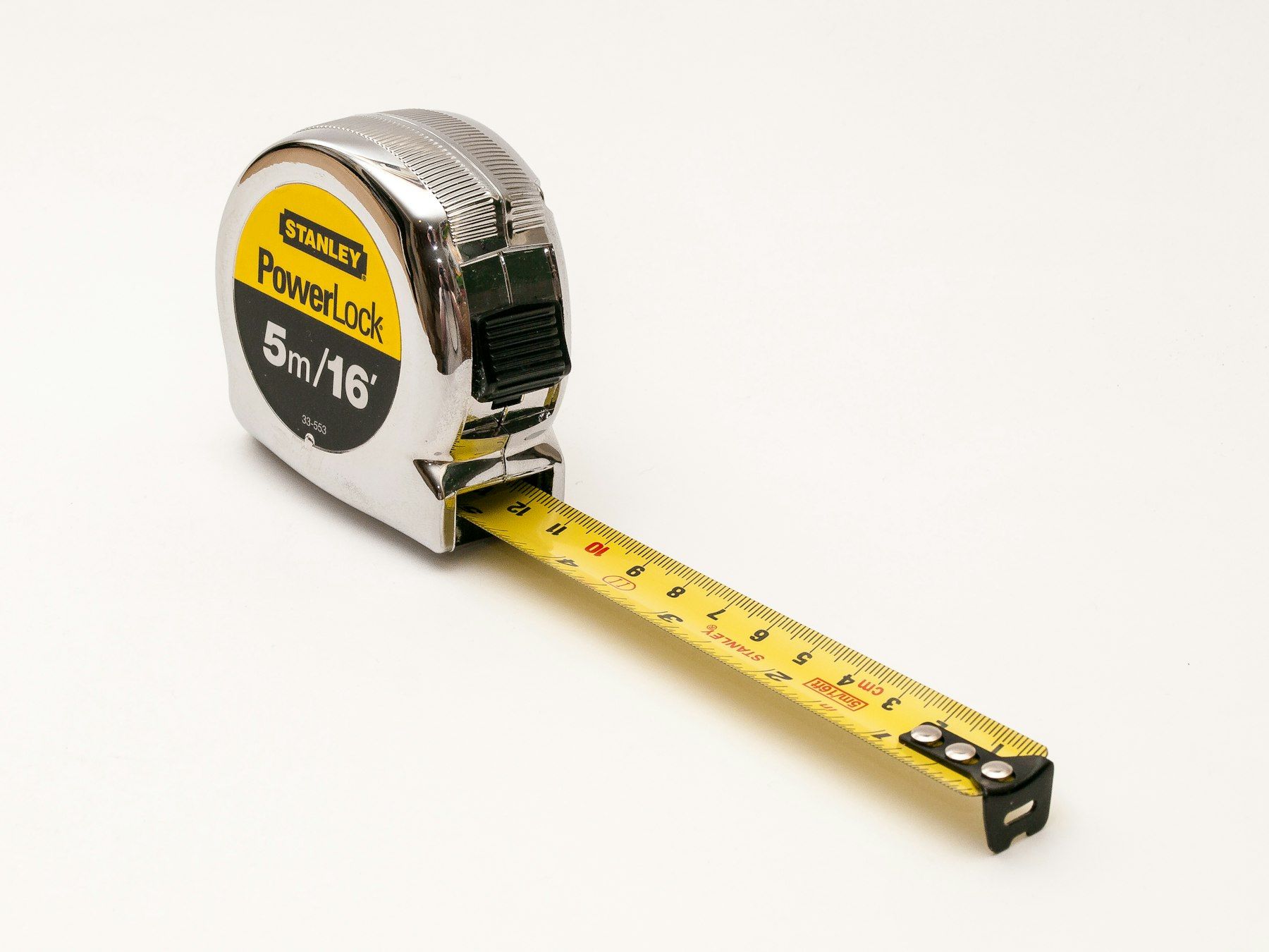 A close up of a tape measure on a white background