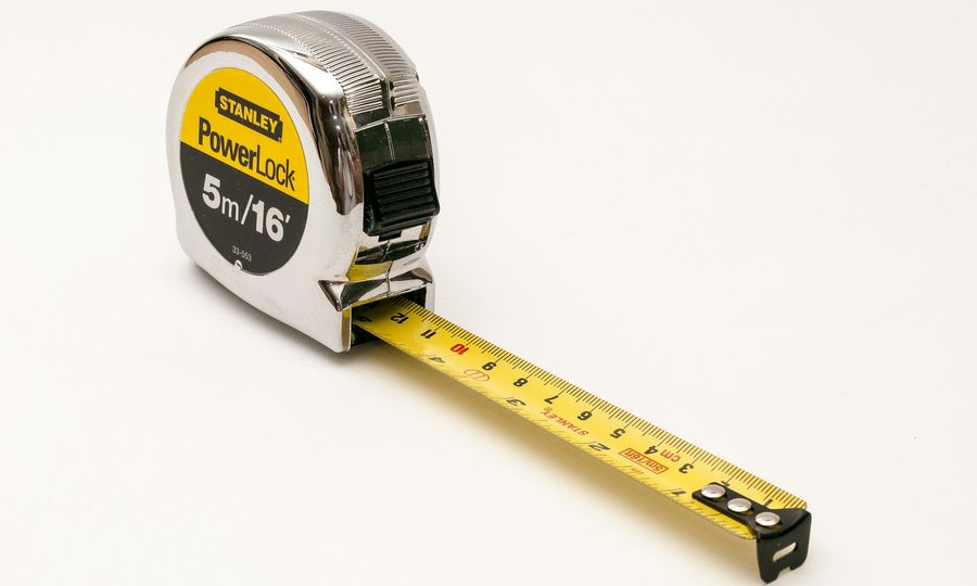 A close up of a tape measure on a white background