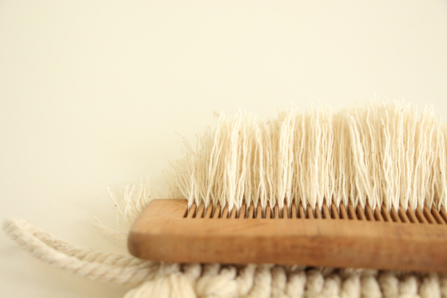 A close up of a brush on a white surface