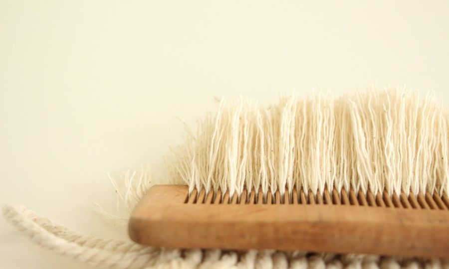 A close up of a brush on a white surface