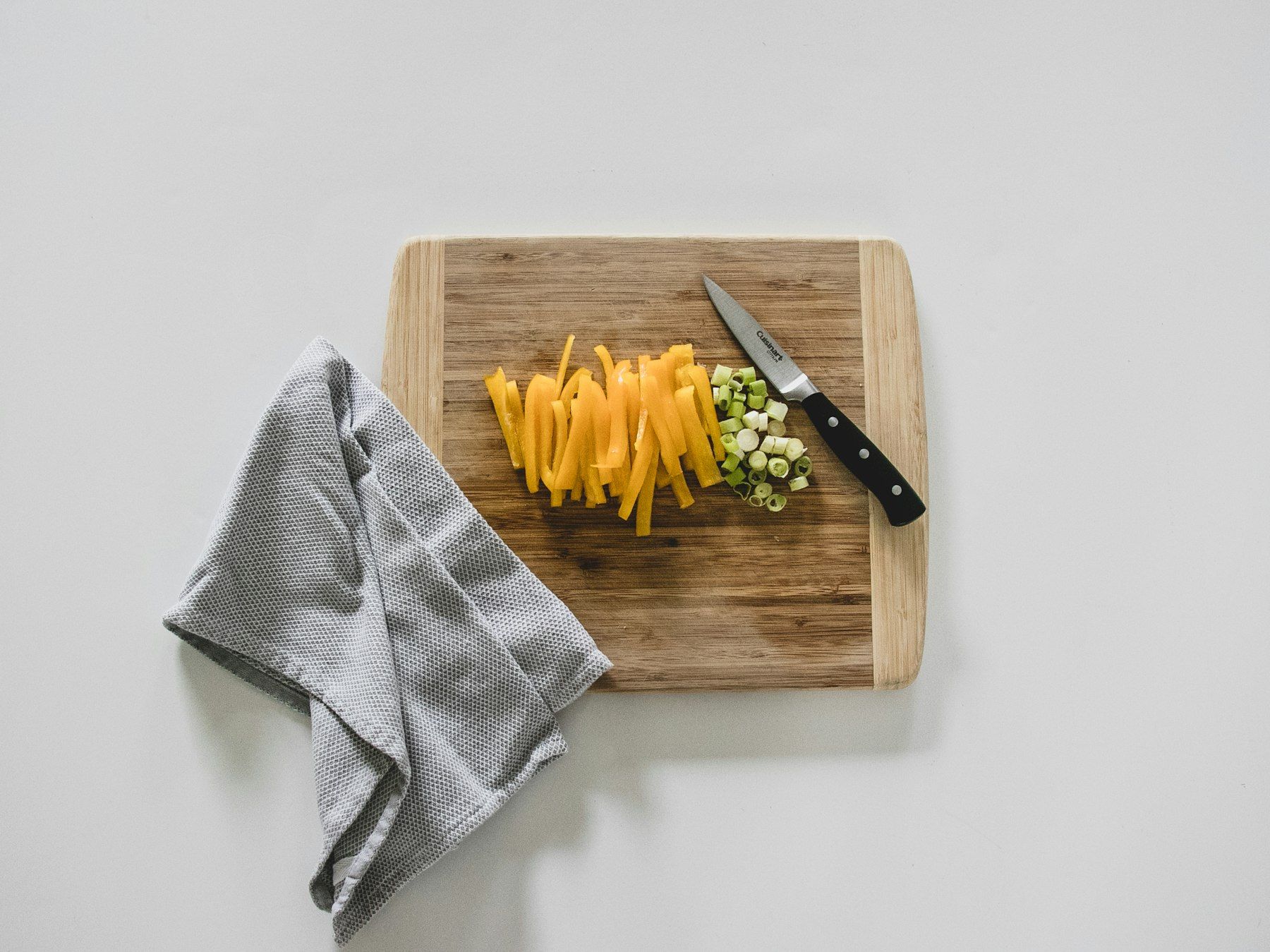 Yellow pasta on brown wooden chopping board