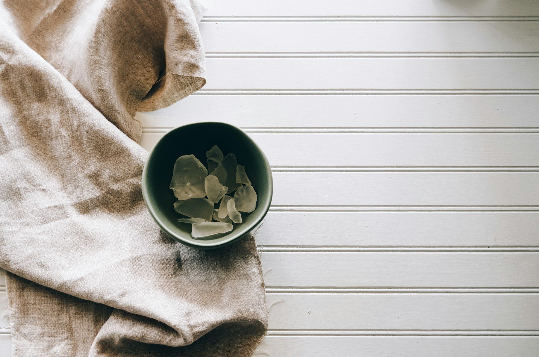 Gray ceramic bowl beside gray textile