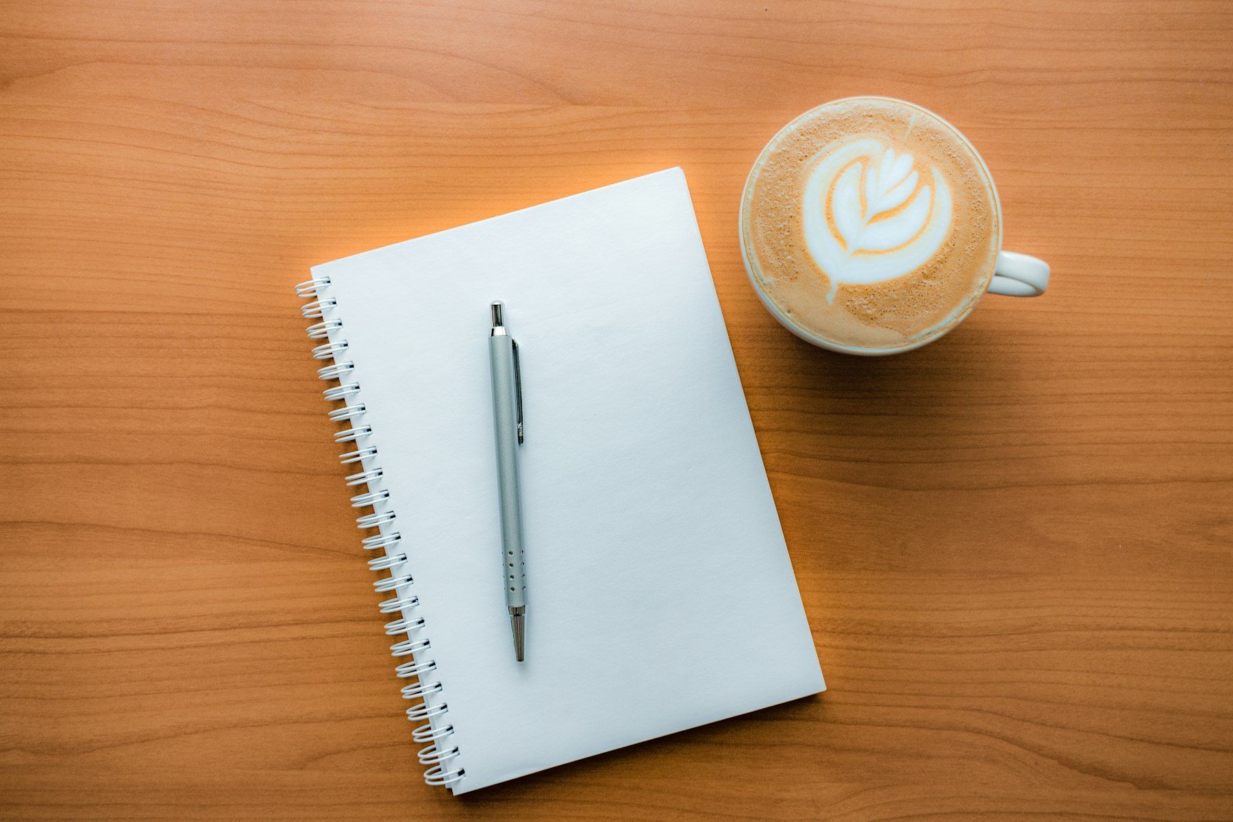 A pen and a cup of coffee