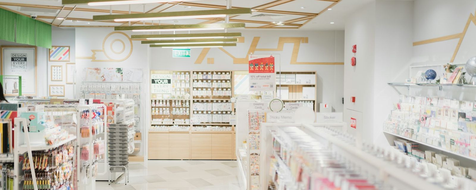 A bright stationery store interior with shelves of greeting cards and office supplies
