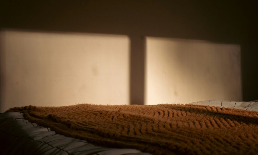 A bed with a blanket on top of it