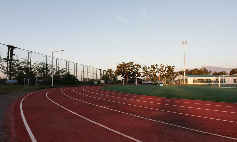 A running track with a fence in the background