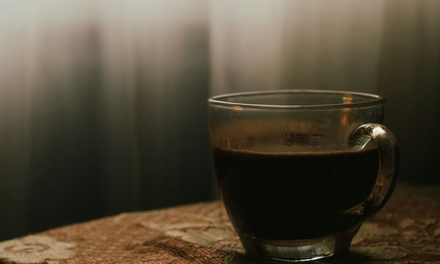 A cup of coffee sitting on top of a wooden table