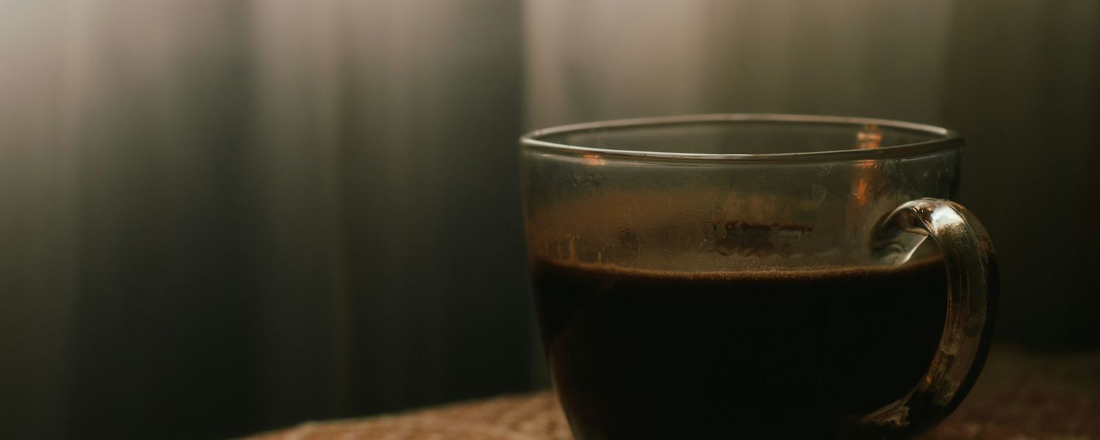 A cup of coffee sitting on top of a wooden table