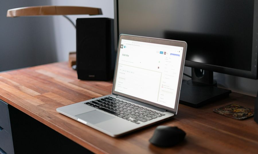 Macbook pro on brown wooden table