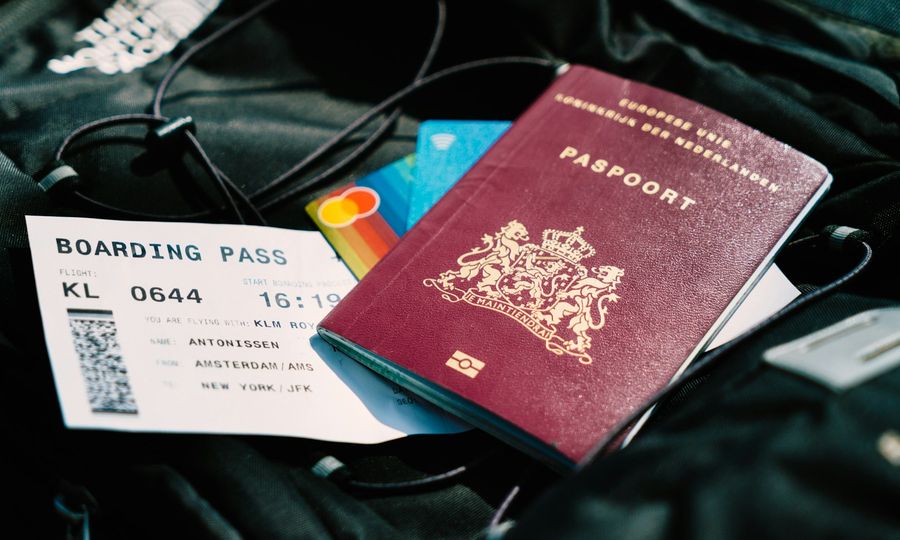 A passport and a boarding pass are on a bag