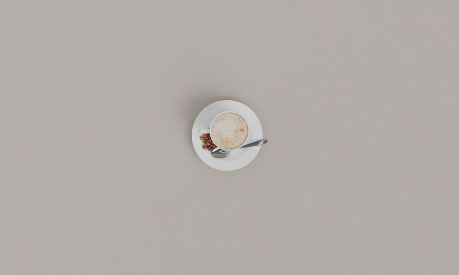 A cup of coffee with cinnamon on a saucer
