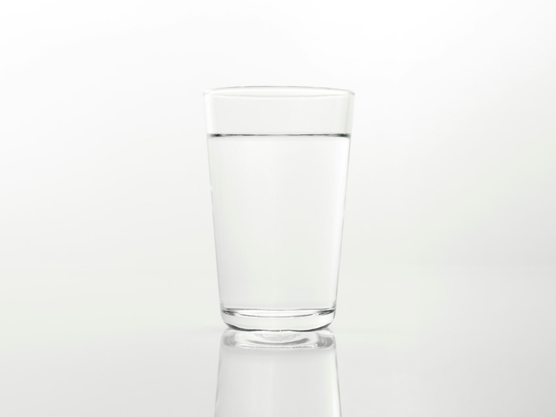 A glass of water on a reflective surface