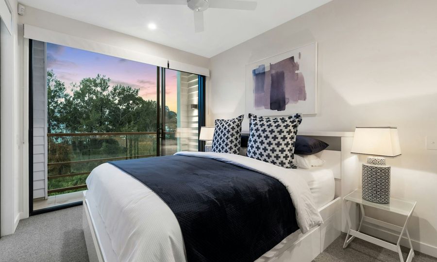 White bed with blue bed linen
