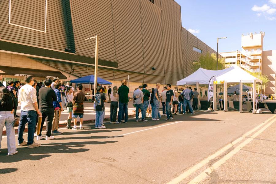 Long line of attendees waiting outside a venue at VIVA PHX 2024.