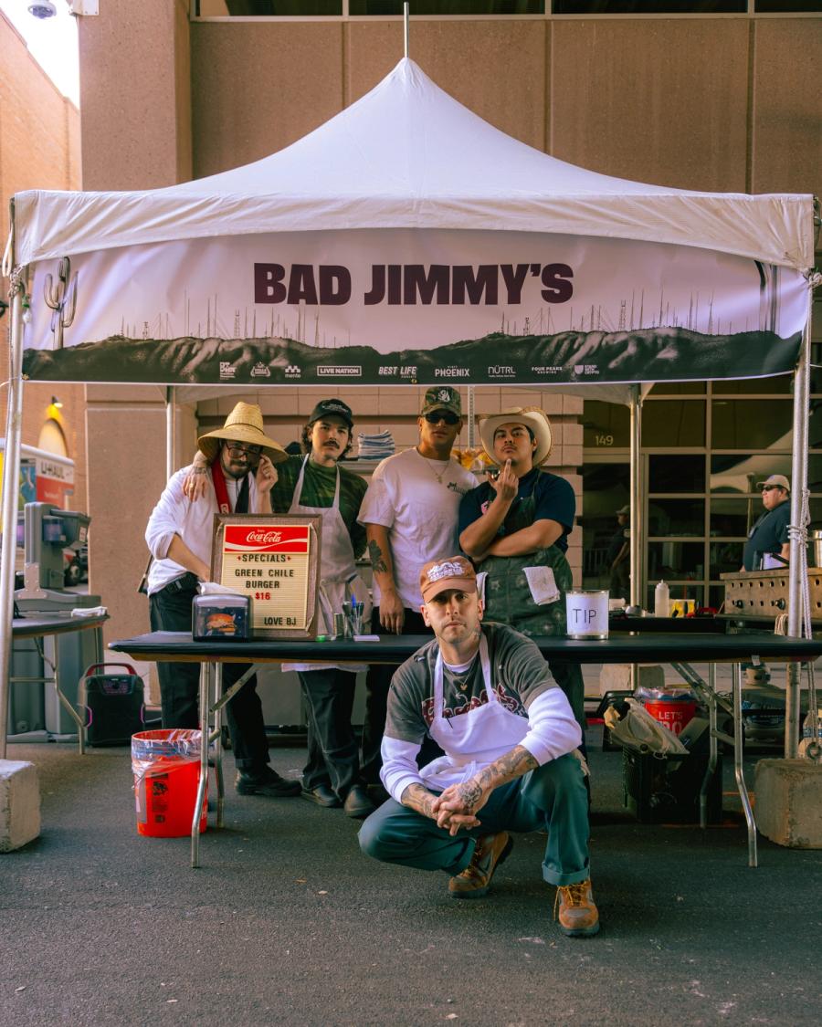 Group portrait of the Bad Jimmy's food crew under their event tent.