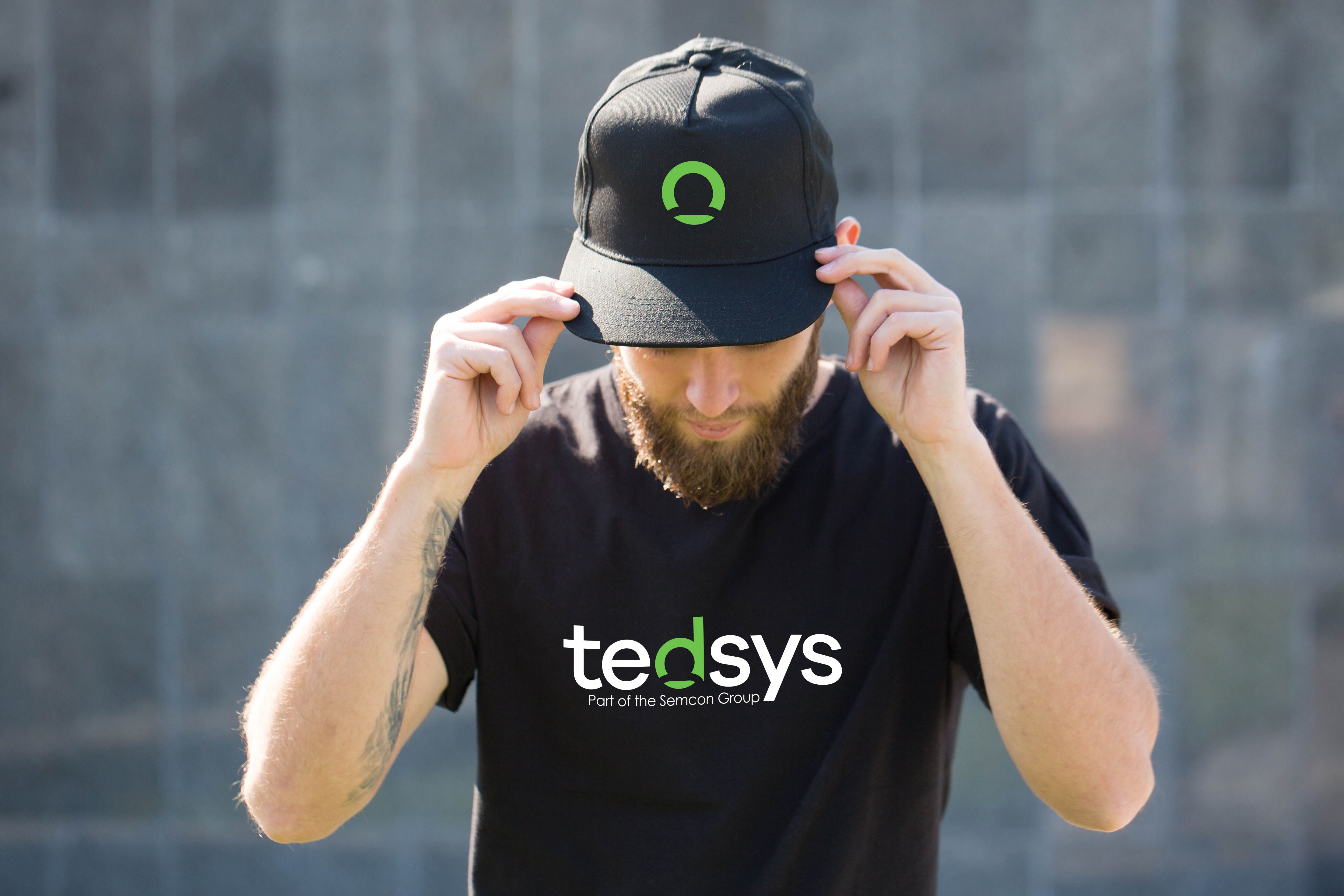 Person with a black cap and t-shirt with the Tedsys logo on them.