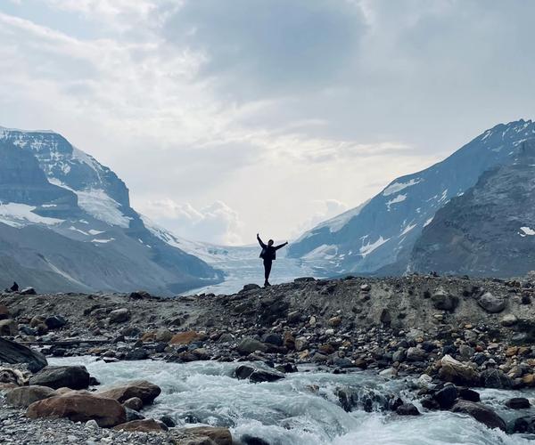posing at the foot of the icefields glacier