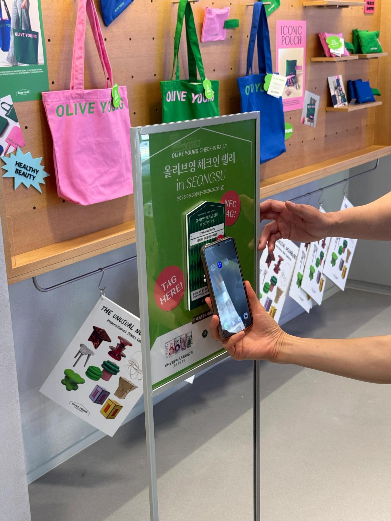 A phone tapping the in-store NFC sign