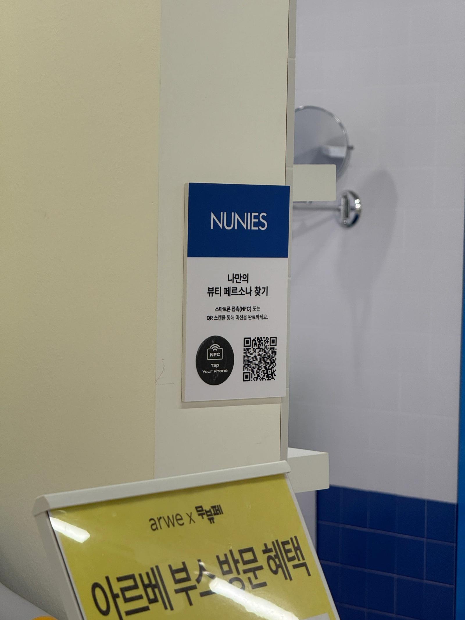 An NFC and QR participation sign at a brand booth