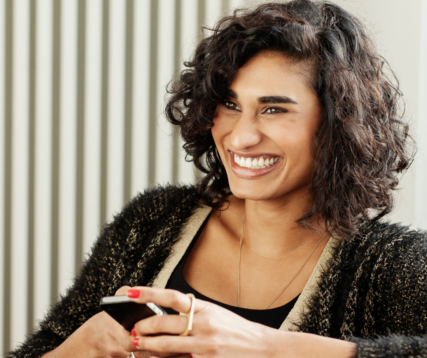 woman smiling holding phone