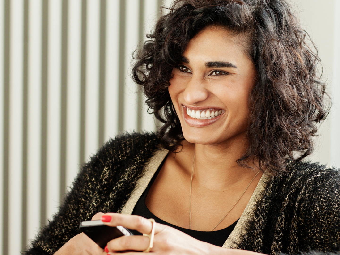 woman smiling holding phone
